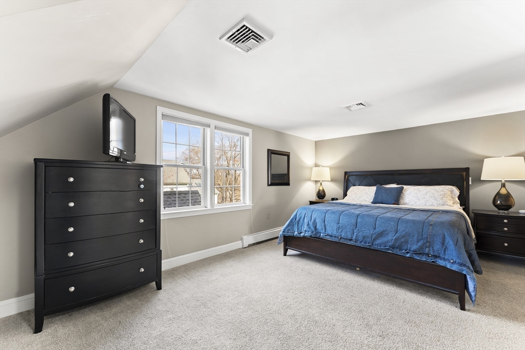 1052 Greendale Avenue Needham, MA 02492 - Photo 20 of 42 a spacious bedroom with a bed and a window