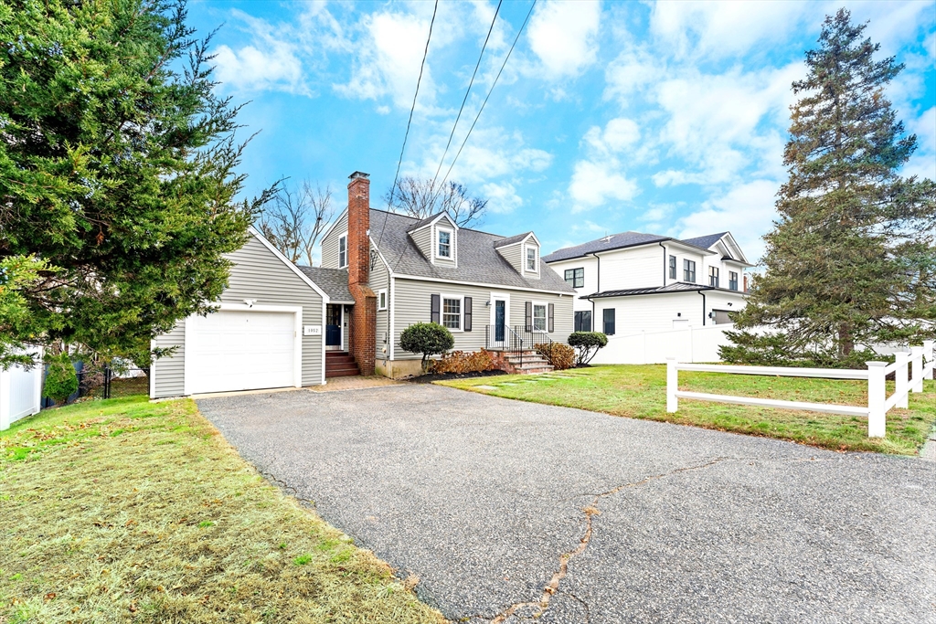 1052 Greendale Avenue Needham, MA 02492 - Photo 2 of 42 a front view of a house with a yard and table and chairs