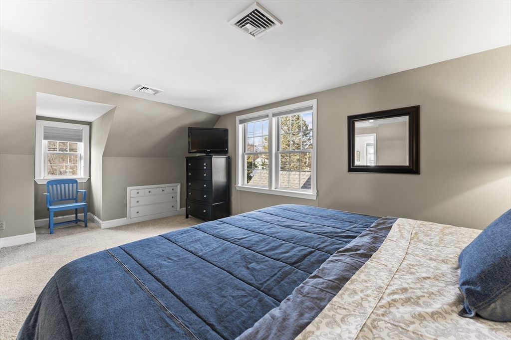 1052 Greendale Avenue Needham, MA 02492 - Photo 21 of 42 a bedroom with a large bed and a window