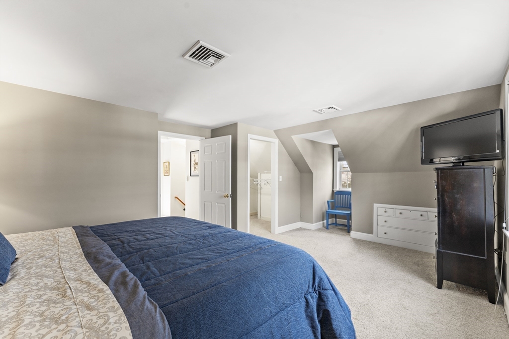 1052 Greendale Avenue Needham, MA 02492 - Photo 22 of 42 a bedroom with a bed and a television in it