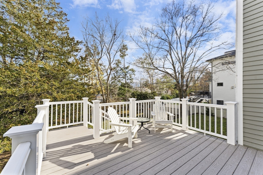 1052 Greendale Avenue Needham, MA 02492 - Photo 36 of 42 a view of a deck with wooden floor and fence with a bench