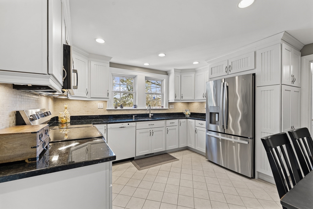 1052 Greendale Avenue Needham, MA 02492 - Photo 8 of 42 a kitchen with granite countertop a sink appliances and cabinets