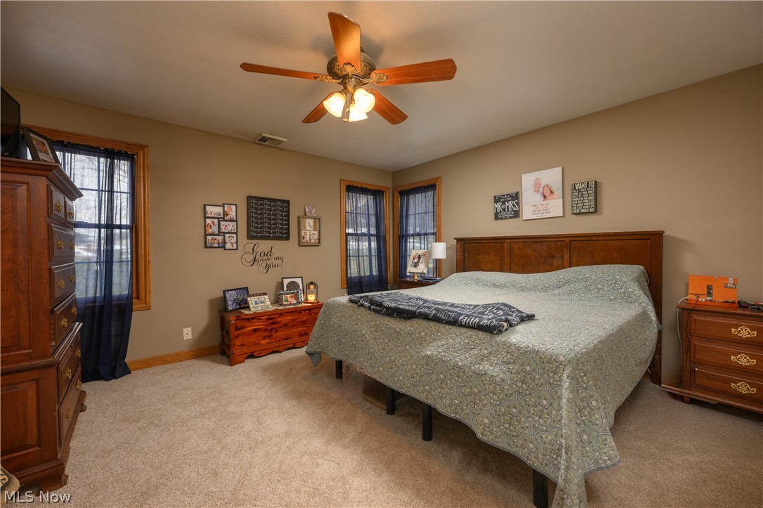 806 Forrest Ridge Drive Dover, OH 44622 - Photo 22 of 36 Carpeted bedroom featuring a ceiling fan and baseboards
