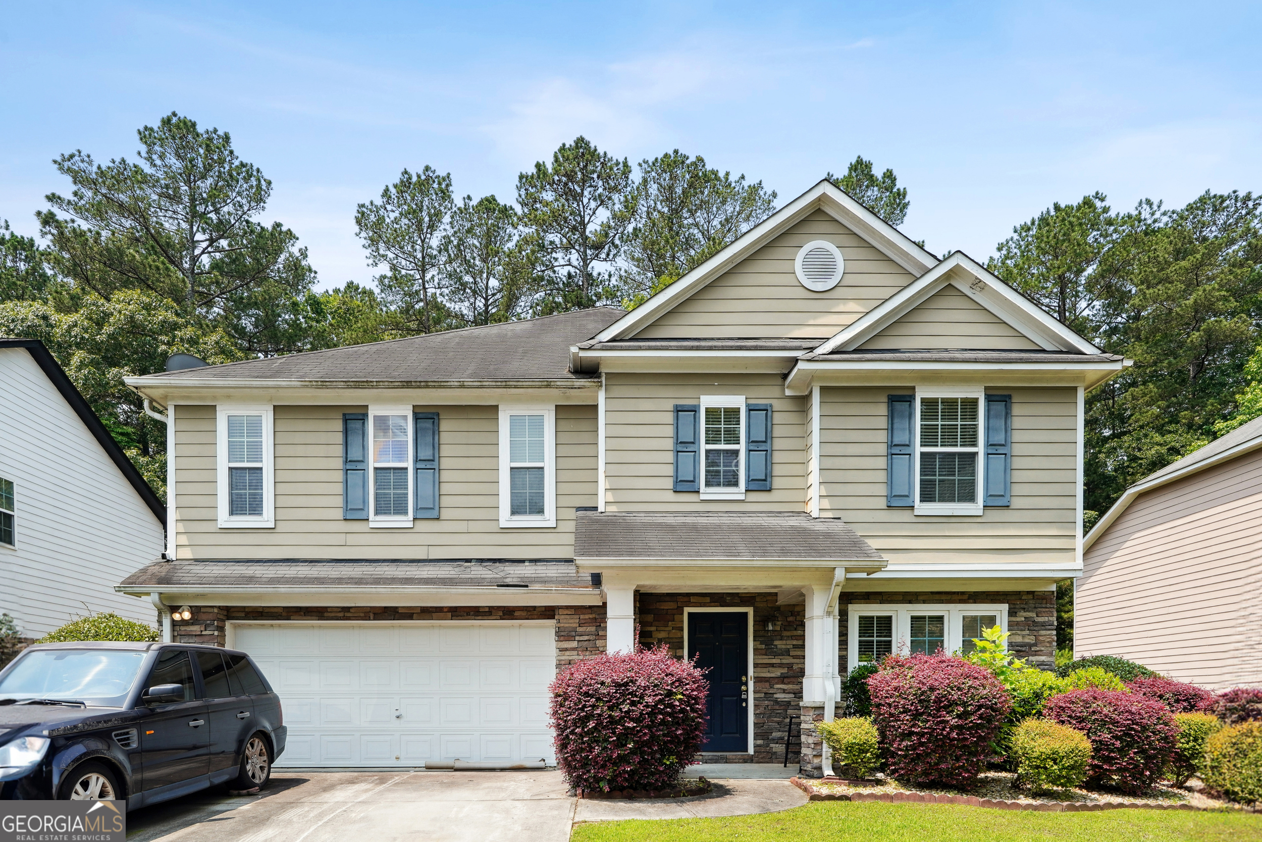 a front view of a house with a garden