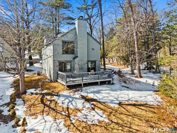 a view of a house with a yard covered in snow