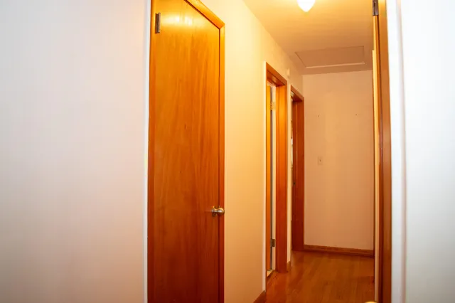 a view of a room with a window and wooden floor