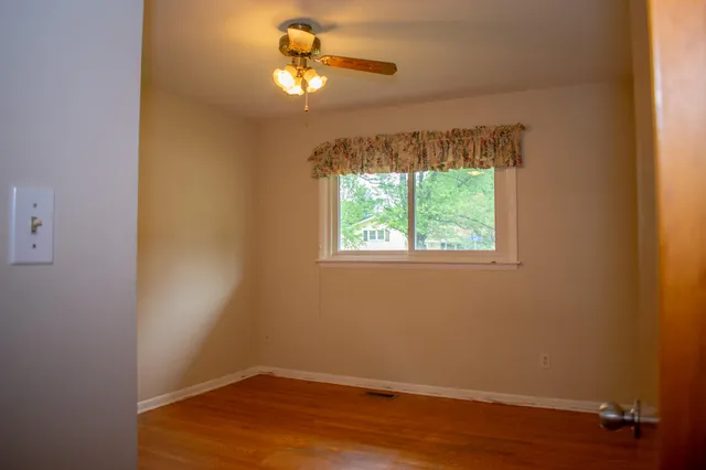 a view of walk in closet with wooden floor