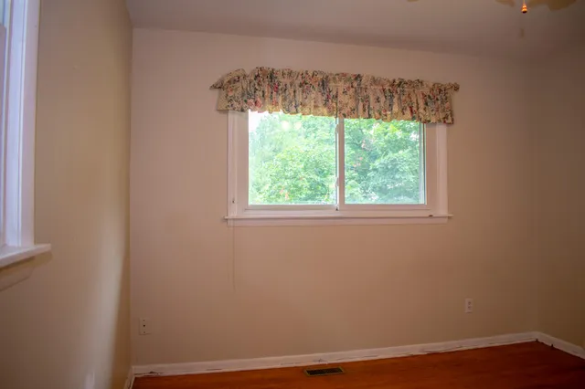 a view of front door with wooden floor
