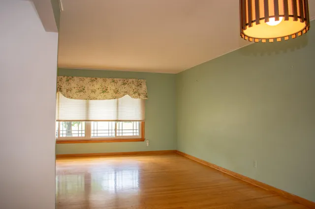 a view of a kitchen with a sink cabinet and a refrigerator
