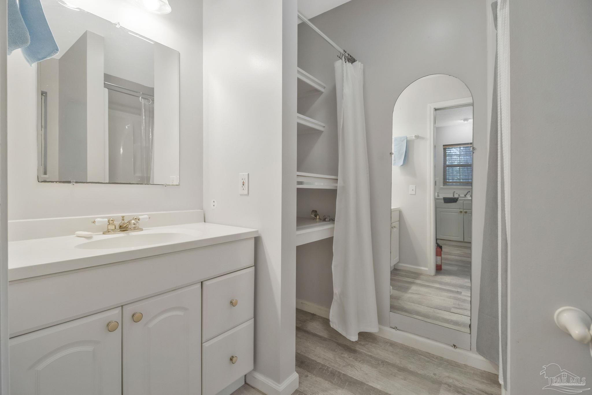 10290 West Lake Road Milton, FL 32583 - Photo 15 of 53 a bathroom with a sink and a mirror