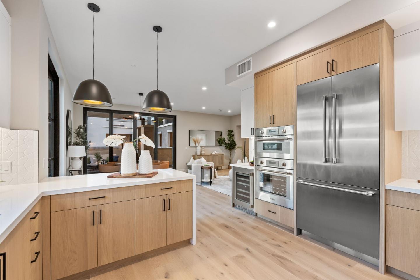229 Hope Street Mountain View, CA 94041 - Photo 18 of 53 a kitchen with kitchen island a counter top space appliances and a view of living room