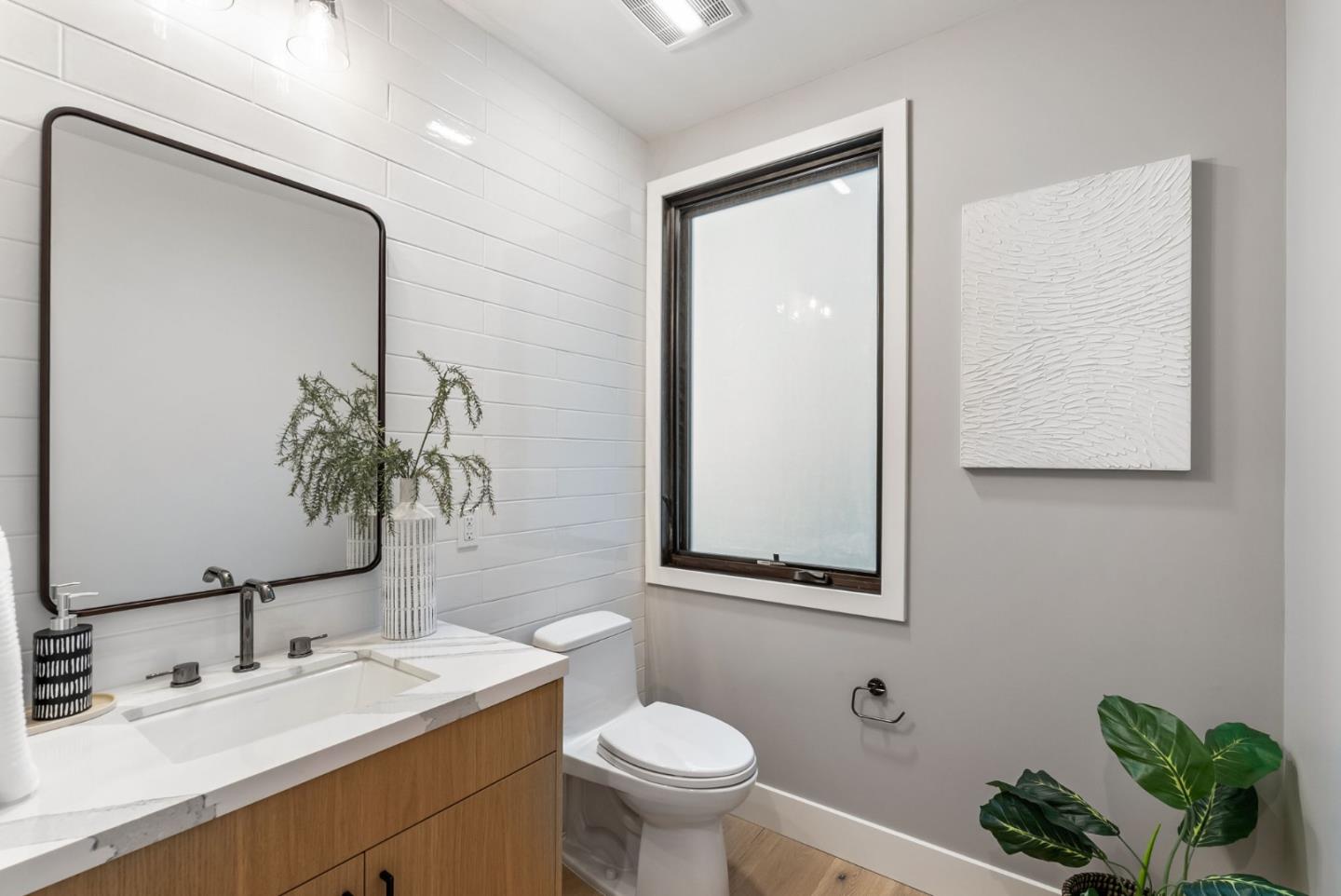 229 Hope Street Mountain View, CA 94041 - Photo 22 of 53 a bathroom with a toilet a sink and mirror