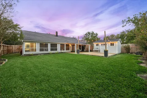 a view of a house with a backyard