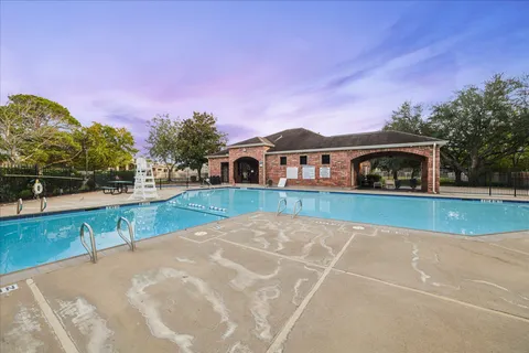 a view of pool with a yard