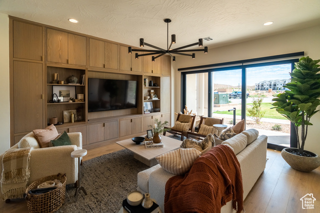 5366 Cyan Lane St. George, UT 84790 - Photo 8 of 39 Living room featuring recessed lighting, light wood finished floors, a textured ceiling, and built in shelves