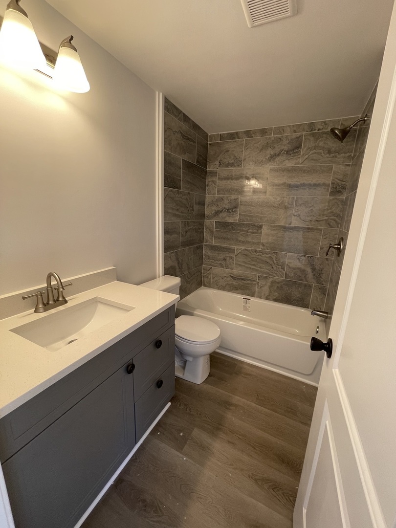102 Candlegate Circle Matteson, IL 60443 - Photo 5 of 11 a bathroom with a granite countertop sink toilet and shower