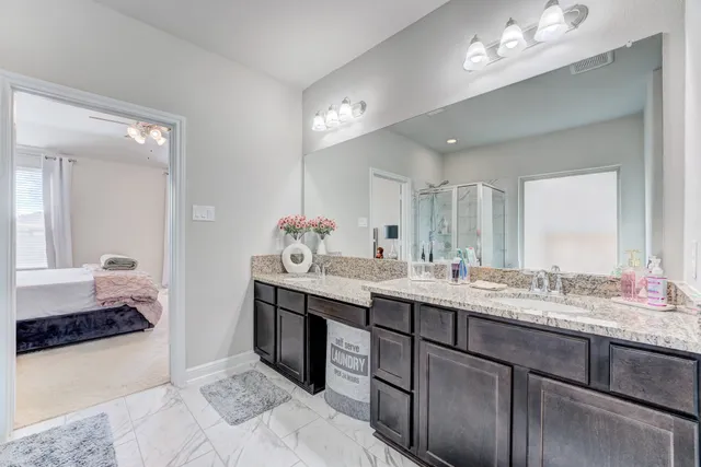 a bathroom with a sink double vanity and a mirror