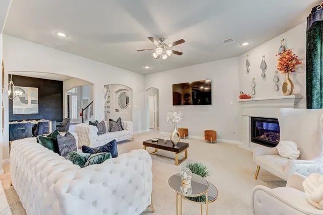a living room with furniture fireplace and flat screen tv