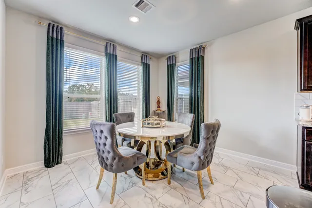 a view of a dining room with furniture and window