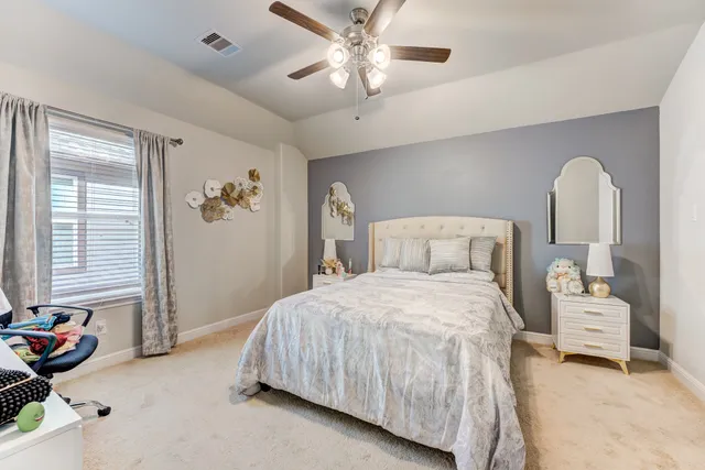 a bedroom with a bed and a chandelier