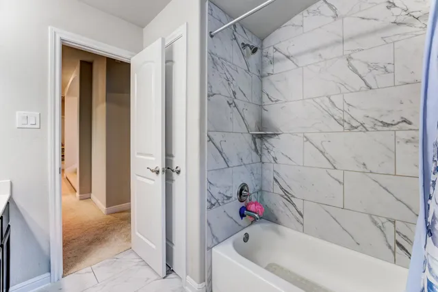 a bathroom with a bathtub and a shower