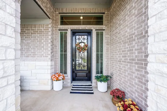 a front view of a house with potted plants
