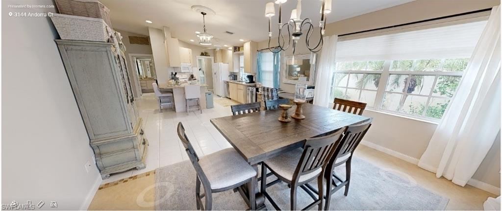 3144 Andorra Court Naples, FL 34109 - Photo 12 of 18 Dining space with a chandelier, recessed lighting, and light tile patterned flooring