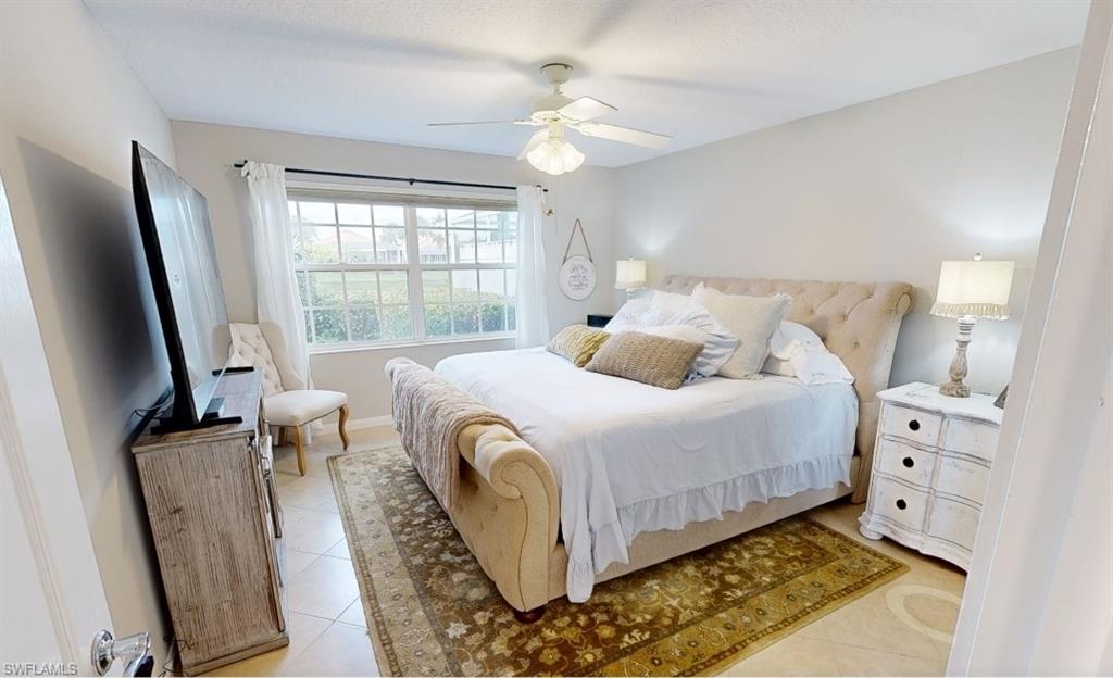 3144 Andorra Court Naples, FL 34109 - Photo 4 of 18 Bedroom with light tile patterned floors and ceiling fan