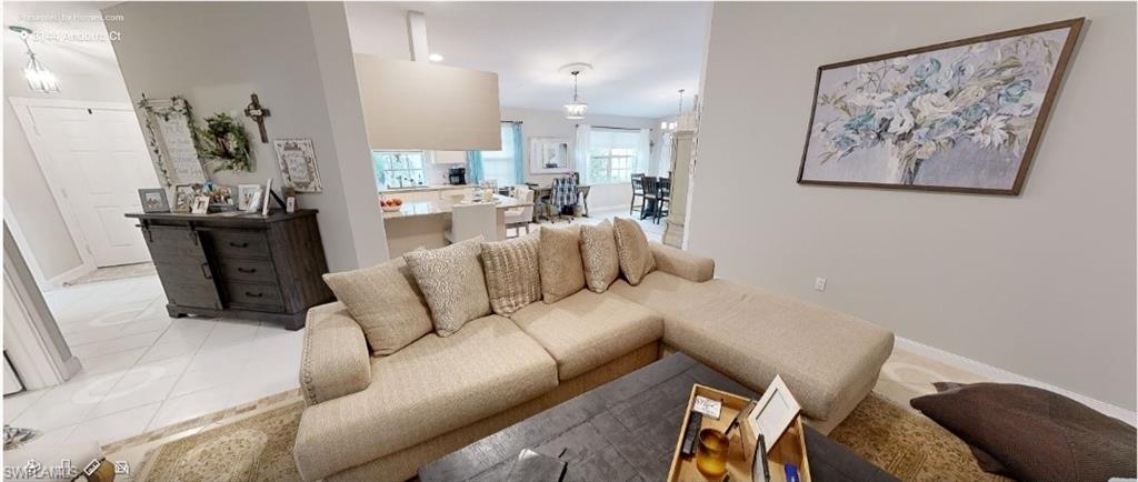 3144 Andorra Court Naples, FL 34109 - Photo 5 of 18 Living room featuring tile patterned floors and baseboards