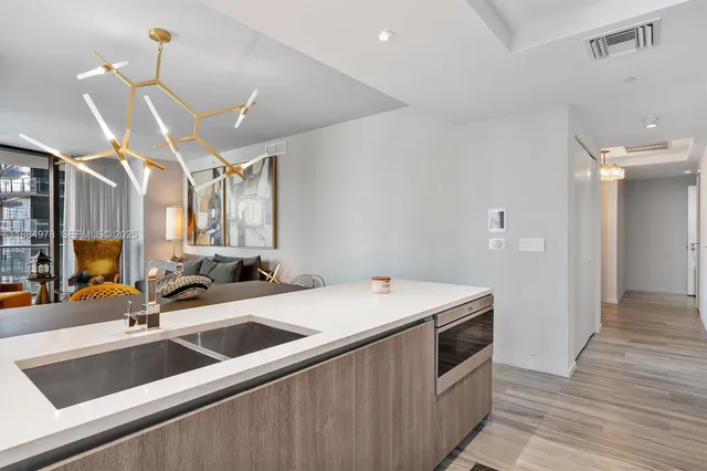 a living room with furniture a rug and a wall painting