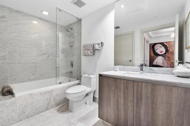 a bedroom with a large bed and a couch