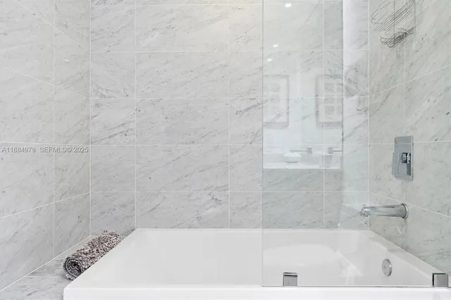 a spacious bathroom with a bathtub and a shower