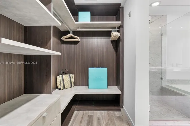 a view of a swimming pool with a lawn chairs and palm trees