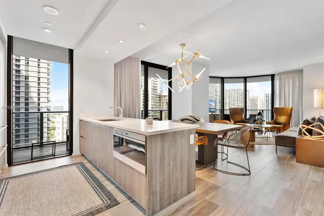 a dining room with furniture and large windows