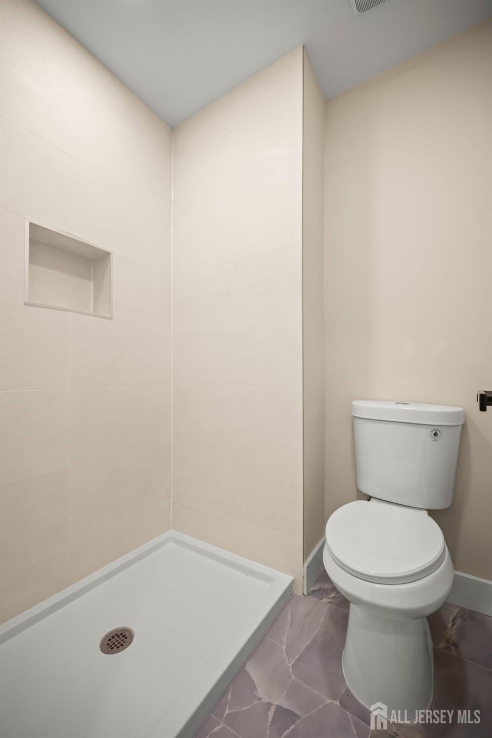 701 Croydon Road, Unit A Monroe Township, NJ 08831 - Photo 28 of 34 a white toilet sitting next to a shower