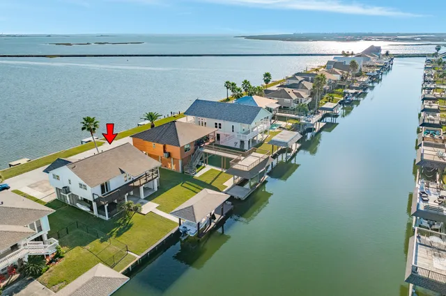 an aerial view of a house with a swimming pool patio and outdoor seating