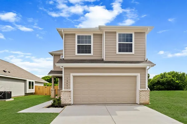 a front view of a house with a garden and garage