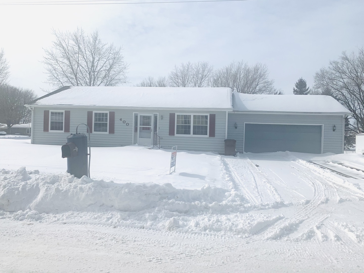 400 Wayne Road Rochelle, IL 61068 - Photo 1 of 9 a front view of a house with a yard and garage