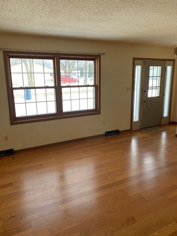 400 Wayne Road Rochelle, IL 61068 - Photo 3 of 9 an empty room with wooden floor and windows