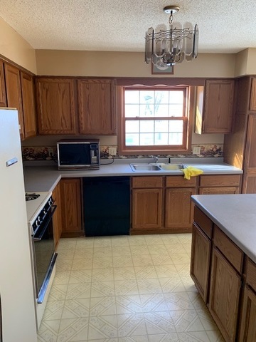 400 Wayne Road Rochelle, IL 61068 - Photo 5 of 9 a kitchen with stainless steel appliances a sink stove and cabinets