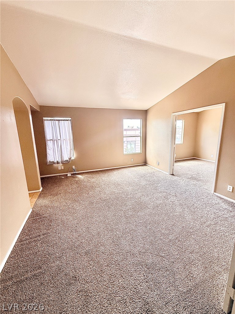 4313 Ranch Foreman Road North Las Vegas, NV 89032 - Photo 10 of 27 Vaulted ceilings and plush carpeting enhance this open living area with natural light.