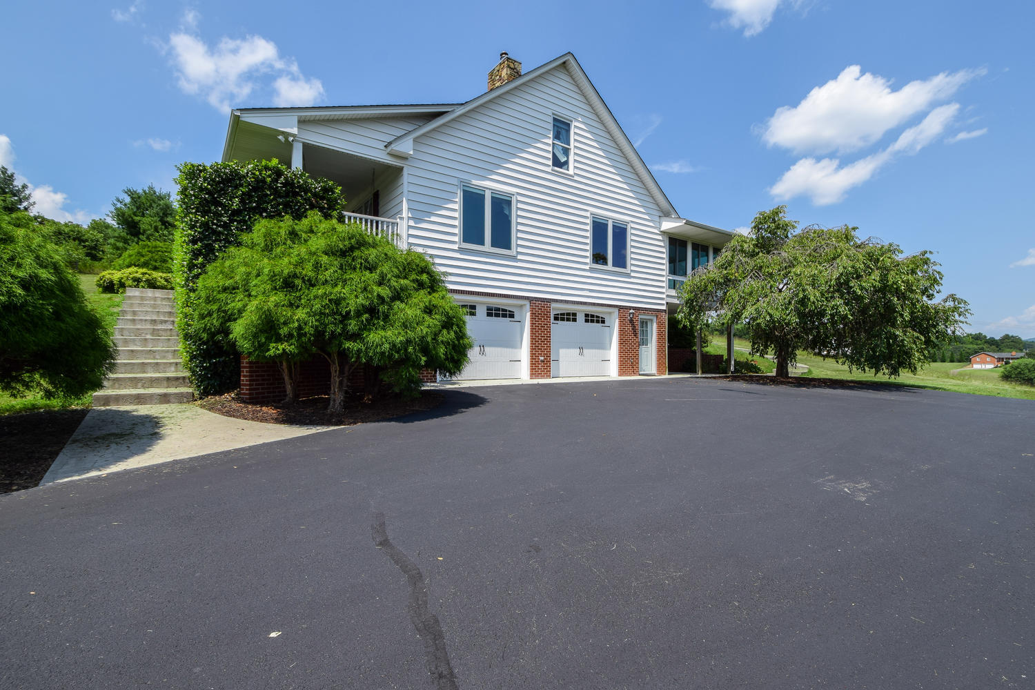 953 Webster Road Roanoke, VA 24012 - Photo 22 of 34 a front view of a house with a yard and a garage