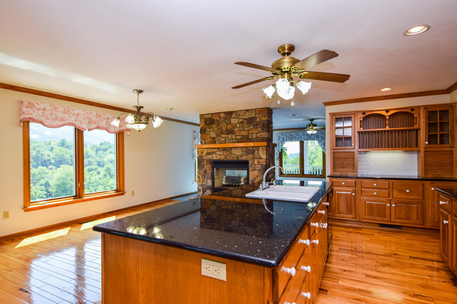 953 Webster Road Roanoke, VA 24012 - Photo 5 of 34 a kitchen with stainless steel appliances granite countertop a stove a sink dishwasher and a dining table with wooden floor