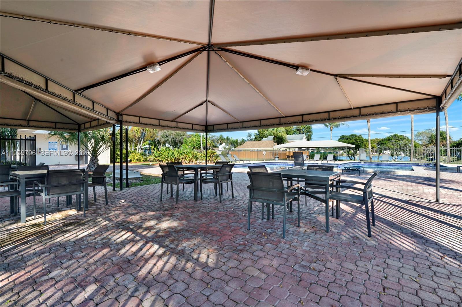 14600 Southwest 124th Place Miami, FL 33186 - Photo 27 of 34 a view of a tables and chairs under an umbrella