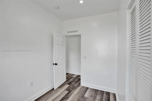 a kitchen with stainless steel appliances granite countertop a refrigerator and a stove