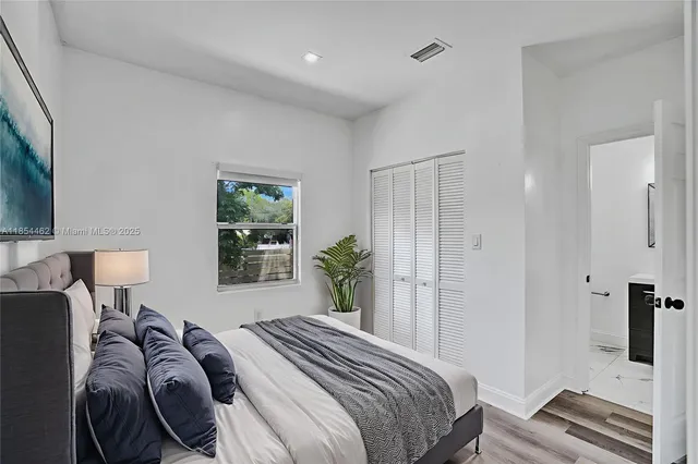 a bedroom with a bed and a lamp