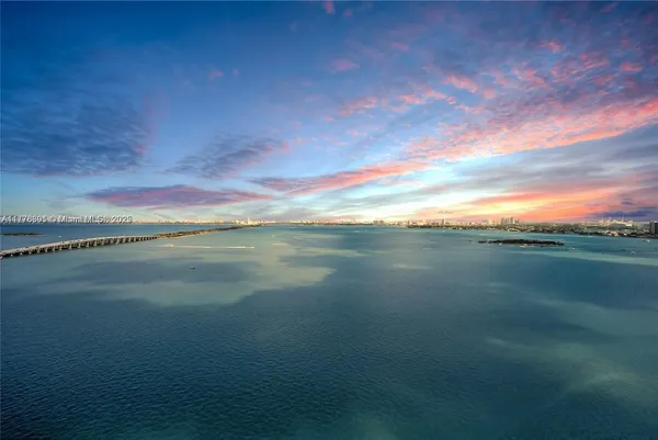 a kitchen with stainless steel appliances a table chairs refrigerator sink and cabinets