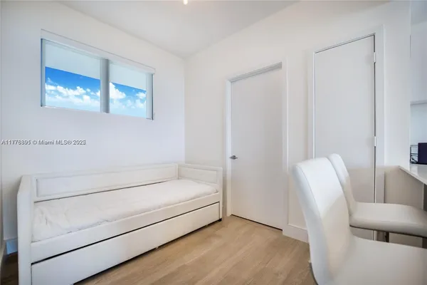 a bedroom with a bed and large window