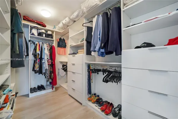 a bedroom with a bed and a large mirror