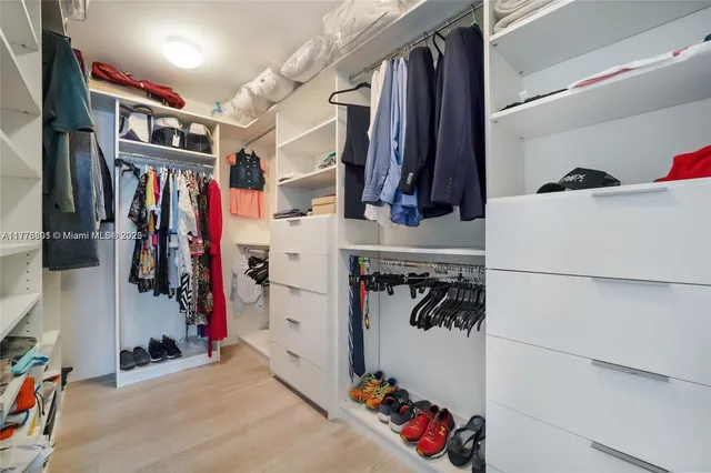 a bedroom with a bed and a large mirror